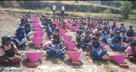 Children sit with their colorful solar cookers, Photo credit: Vivek Kabra