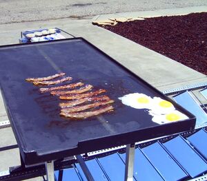 Bacon and eggs cooking on the --Solar Fryer--