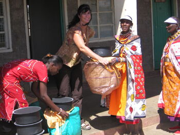 Karyn Ellis giving solar kits to Orinie Masai group