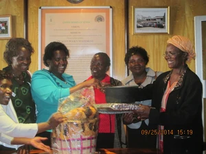 Mama solar presents Roger Hains solar cooker and fireless cooker to Alliance of Women in coffee after training at the coffee plaza in Nairobi