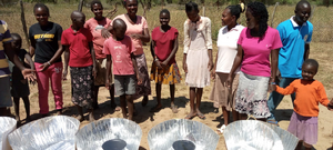 Participants pose with the Haines 1 solar cookers