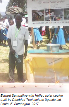 Edward Sembajjwe demonstrates the Heliac solar cooker, 6-22-17