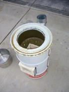 180px-Improvedfuel9.jpg (7 KB) CCAT demo stove, Humbolt, Ca.