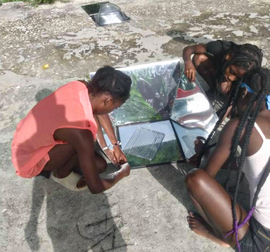 Girls learn to assemble the solar cookers