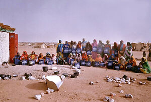 Iridimi refugee holding solar cookers