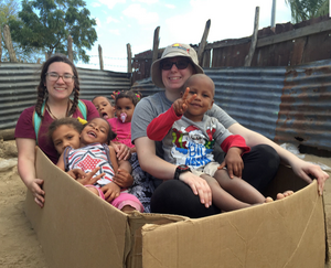  volunteers watch over young children while their parents attend a solar cooking workshop in the Dominican Republic