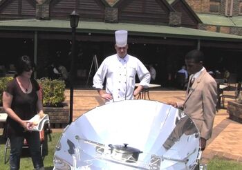 Thea Holm demonstrates solar cooking to chef, 2-21-13