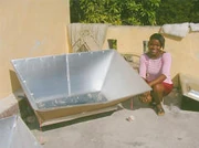 Haiti woman tests reflectors for Dakota Sunstove