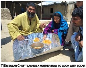 A workshop trainer from TIE teaches a mother how to use her new CooKit, 3-10-14 