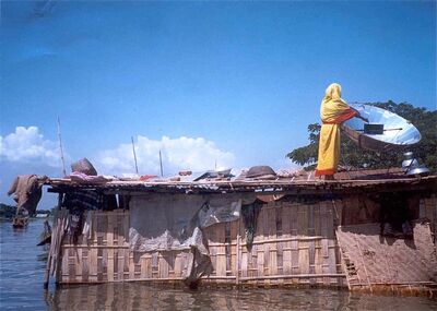 Bangladeshi woman cooking in flood