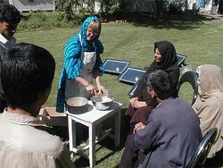 Grace Magney demonstrating solar cooking in Afghanistan