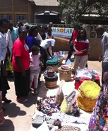 Faustine Odaba, Lucy Odaba and Nicholas Okeya present solar cookers and haybaskets during a festivity of the Catholic Church in Nairobi. Photo: Bernhard Müller