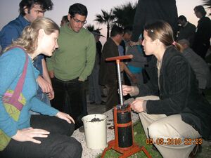 Briquette press being demonstrated at  conference in 2010