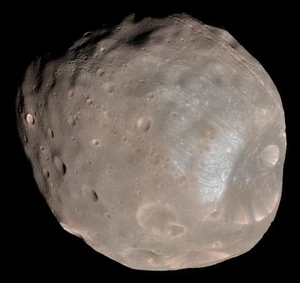 The larger moon, Phobos, is indeed seen to be a cratered, asteroid-like object in this stunning color image from the Mars Reconnaissance Orbiter, recorded at a resolution of about seven meters per pixel.