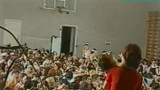 Hundreds of hostages crowd the school gymnasium as wired explosives hung from the basketball hoops  hang precariously above them
