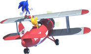 Cropped artwork of Sonic and Tails riding the Tornado.