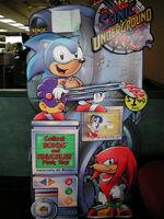 A display stand for the promotion. Note Sonic's stretchy-looking arm and shorter section of his guitar.
