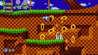 Sonic taking damage while holding a Hyper Ring in Sonic Mania. Note the presence of multiple large Rings as opposed to a single Ring.