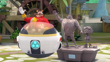 Eggman and his Eggmobile next to Eggman's amusement part statue.