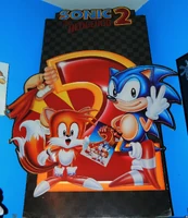European stand of Sonic, Tails and Dr. Eggman with a large "2". Illustrated by Duncan Gutteridge.