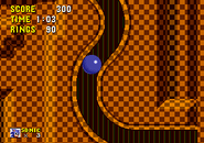 Sonic curling down the tunnel in original Sonic the Hedgehog.