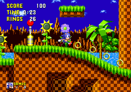 Screenshot depicting Sonic in a 2D space with a colorful grassland, slopes, hovering golden rings, and a lamp post. The top left has "score", "time", and "rings" counters, while the bottom left has the number of lives in the player's posession.