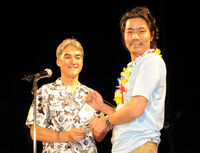 Former Xbox Japan head Takashi Sensui offering director/producer Kenjiro Morimoto the award for Sonic Free Riders