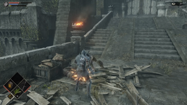 Gameplay screenshot of Demon's Souls showcasing blocking an enemy while a portion of the stamina meter is depleted. A remake of the 2009 game of the same name, Demon's Souls retains a methodical combat system governed by stamina management, while possessing upgraded visuals, technical refinements and an overhauled heads-up display.
