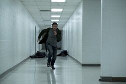 Eddie Brock running down a hallway promotional still