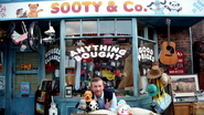 Promotional image of Matthew, Sooty, Sweep and Soo outside the shop