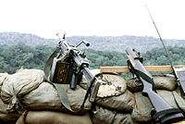 M79 (right) with an FN Minimi.