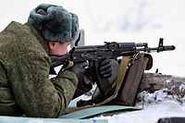 Russian Airborne Troops (VDV) soldier firing an AK-74M rifle.