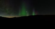 Aurora, with a globular cluster seen behind it