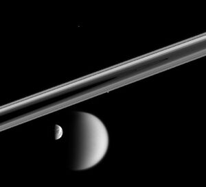 Four of Saturn's moons: , ,  (edge of rings),  (top center)