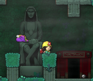 Using the Eggplant Child to open the door to Eggplant World by placing them on the Mother Statue.