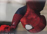 Close up on Spider-Man holding something on set