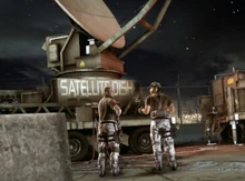 Two members from the private military company "" guard a satellite dish at  during the .