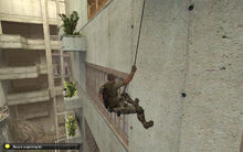 Fisher scales the side of the hotel as he attempts to beat Emile Dufraisne back to the garage/parking lot.