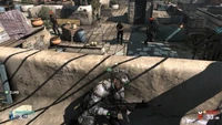 Sam takes cover behind a wall from enemies.