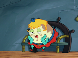 An angry Mrs. Puff sits in the chair impatiently.