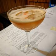 A glass of whiskey on top of this episode's script.