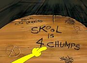 Closeup of the "Skool is 4 Chumps" desk.