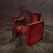 The specter sitting on the chair in-game.
