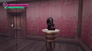 The Doll on its pedestal.