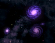 A group of nearby galaxies, clearly visible in a planet's night sky.