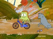 Wolf letting Rusty ride a bike of his own