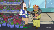 Ellis tells an employee named Billy to hold his firearm while Ellis picks up a pot of hydrangea flowers