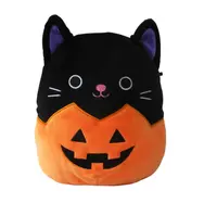 photo of cat half in pumpkin.