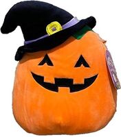 A photo of a toy pumpkin wearing a hat.