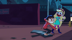 S1e1 marco standing on sign